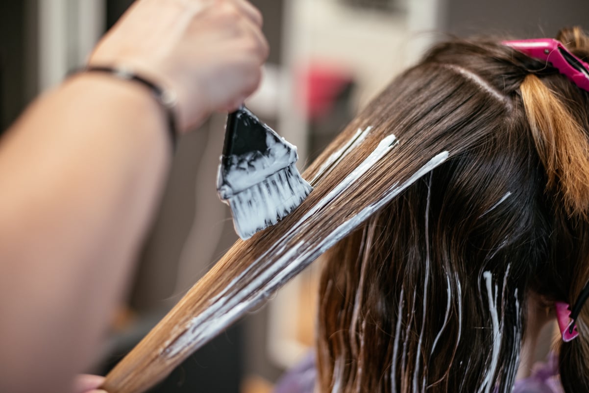 Hairdresser dyeing a woman's hair