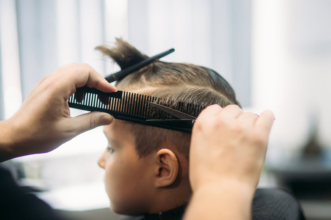 Little Boy Getting Haircut  at Barbershop